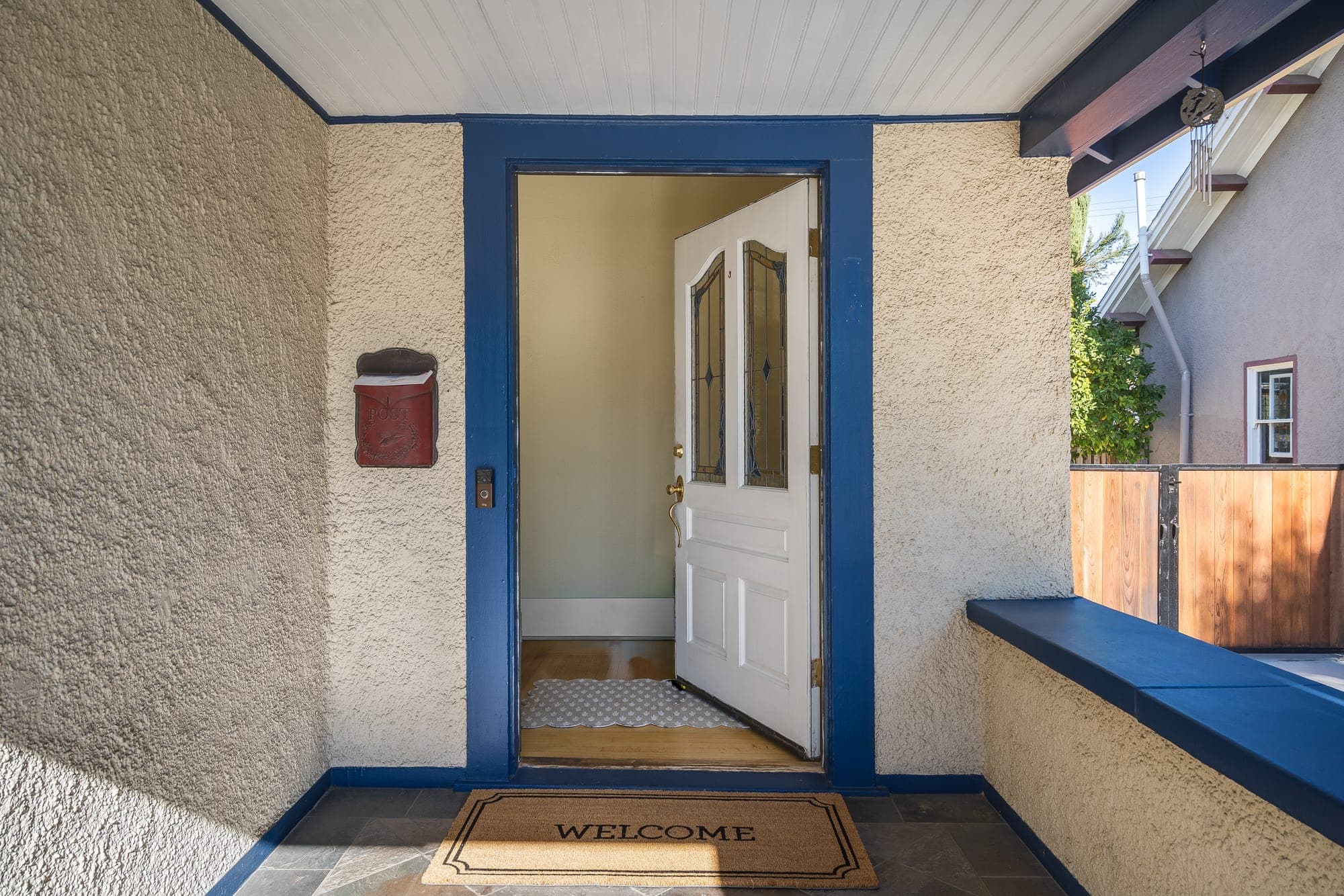 The covered entry porch with the front door open to the foyer.