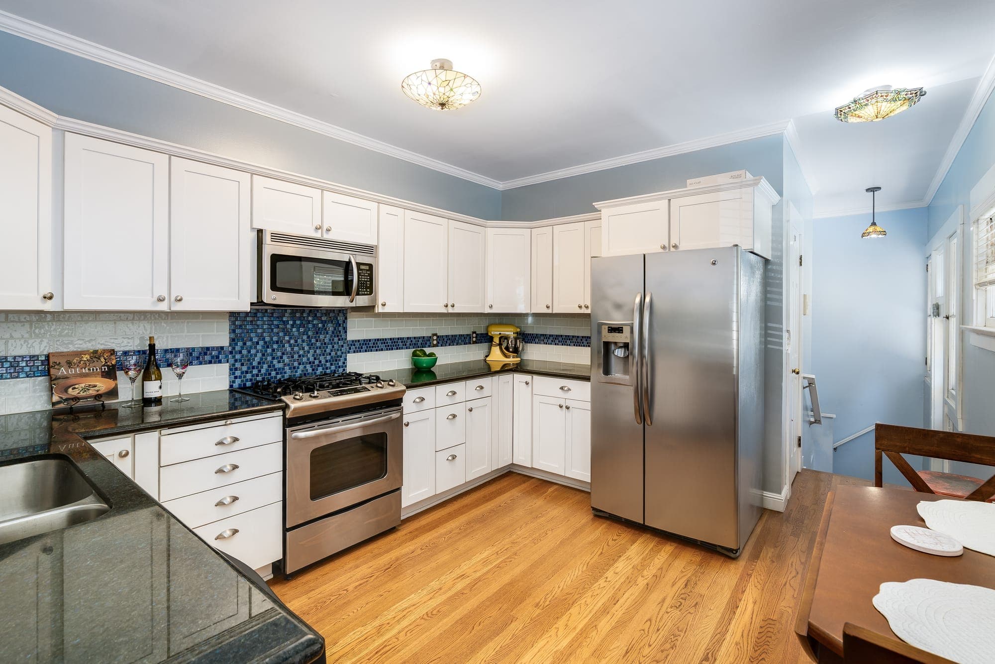 The kitchen from the breakfast nook, toward the range and refrigerator.