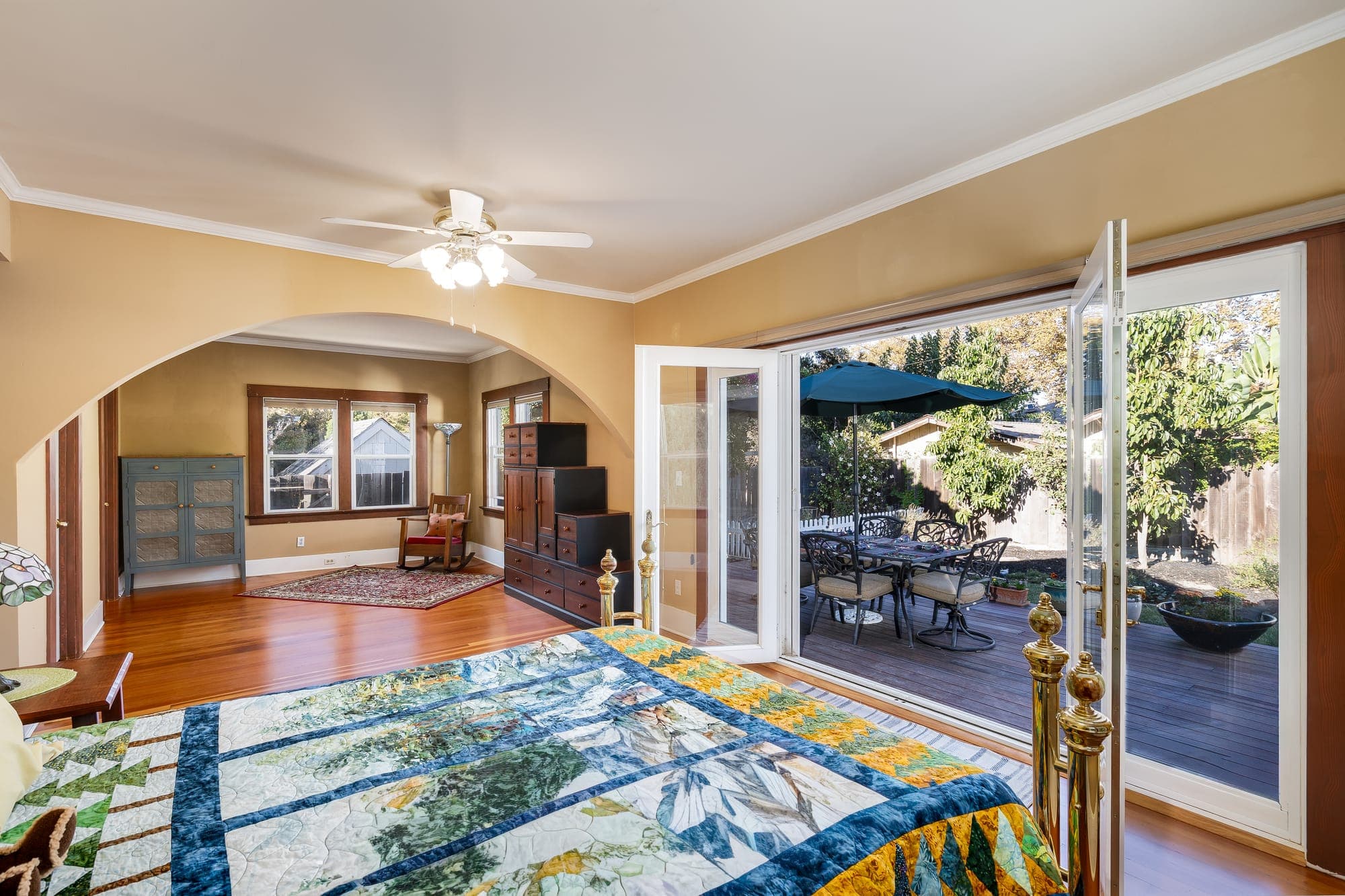 The bedroom's French doors open to the rear deck and garden.