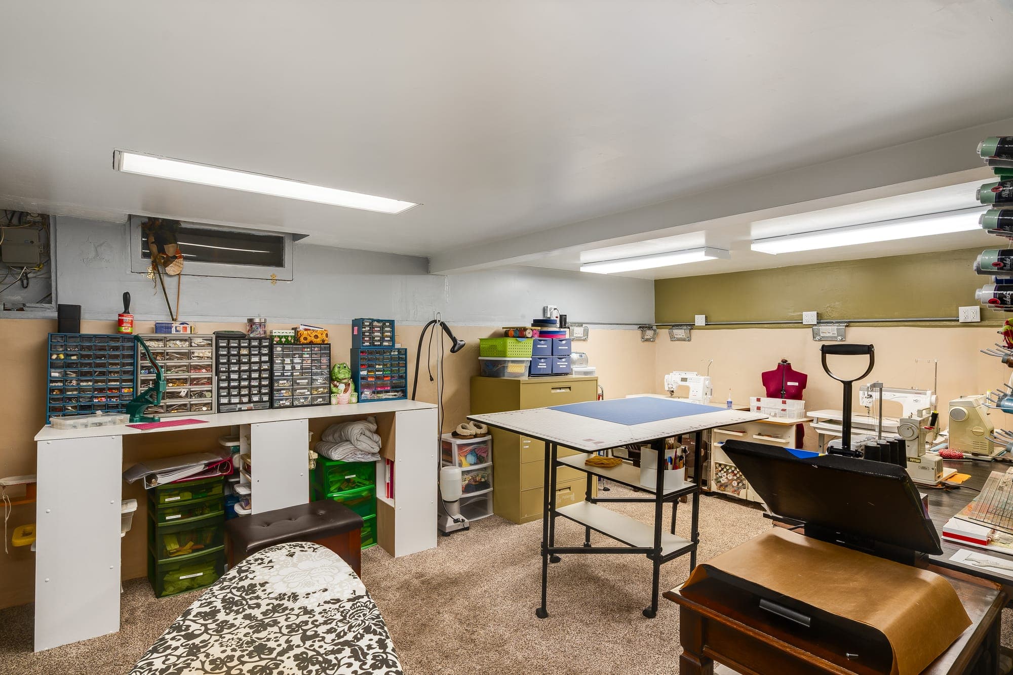 The finished lower-level room, currently set up as a workroom.