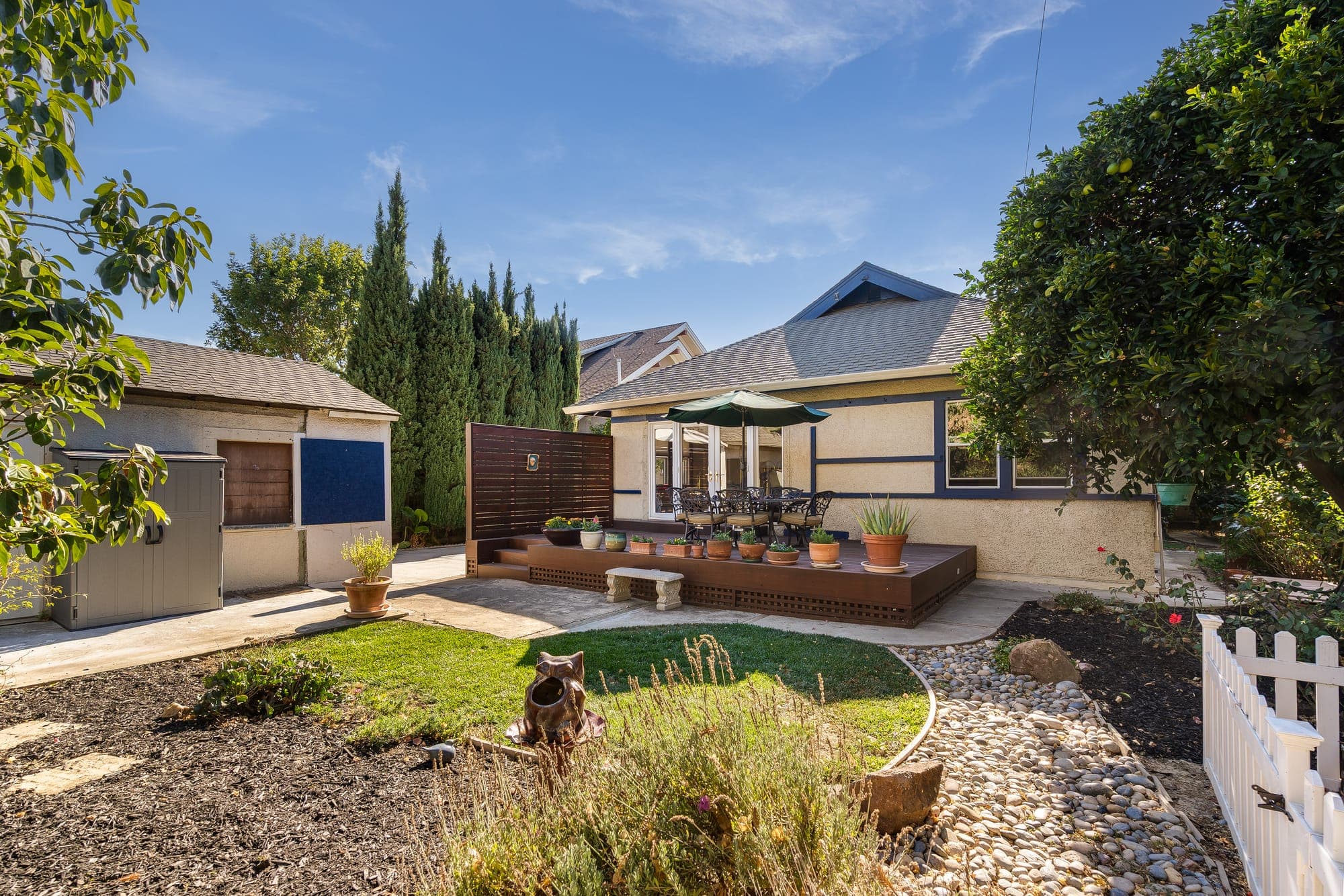 The rear garden, lawn, and detached garage.