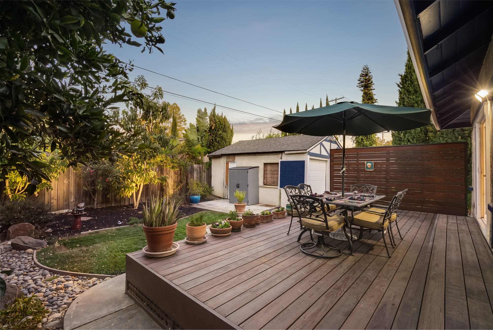 The rear deck at twilight, set for dinner under the umbrella.