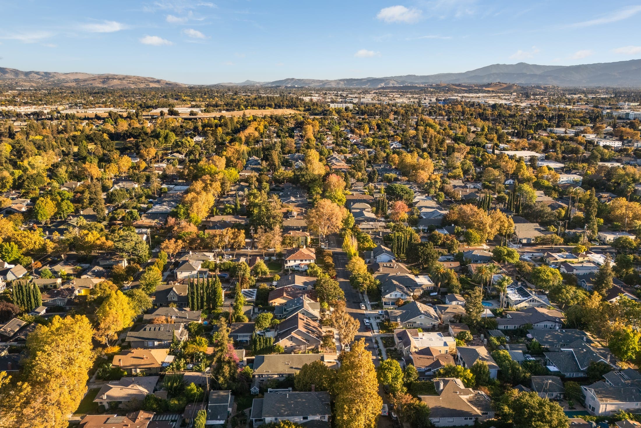 Aerial view of the neighborhood's tree-lined streets running toward the eastern foothills.